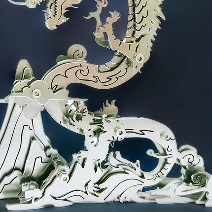 Close-up of a silver steampunk dragon metal model's base and lower body, intricately designed with mountain and cloud motifs, highlighting the detailed craftsmanship of this mechanical steampunk 3D puzzle Metal Kit.