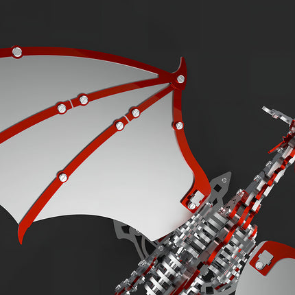 Close-up of the metal model dragon's wing with striking red mechanical steampunk framework and silver membranes, illustrating its connection to the body. This 3D puzzle metal kit offers vibrant details for a steampunk puzzle.
