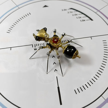 Unique steampunk ant 3D puzzle metal kit on a white measurement surface, featuring a glossy black abdomen, intricate mechanical steampunk components, and a golden head with a red centerpiece.