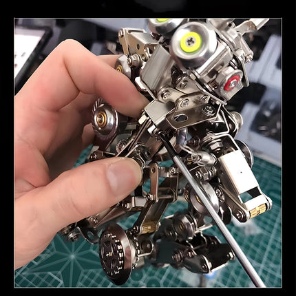 Hands assembling a "Monkey King 2" metal model kit with tools, showcasing the engaging DIY building experience.