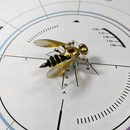  Highly detailed steampunk bee 3D puzzle metal kit on a white measurement mat, showcasing its elaborate golden filigree wings, mechanical steampunk body, and distinctive segmented abdomen.