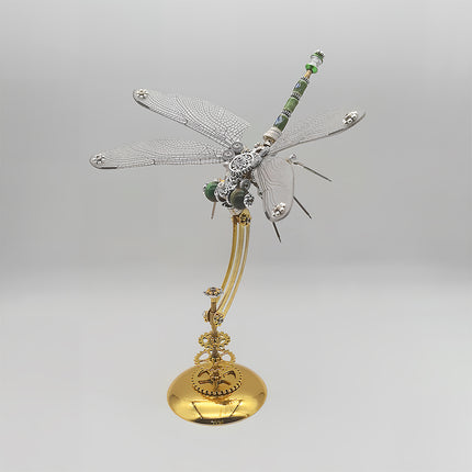 This is a finished Tablefunny steampunk dragonfly 3D metal puzzle: crafted from silver and gold-toned metal, its wings replicate the dragonfly’s fine texture, the head has green accents, and the body + gold base feature steampunk elements like gears. Paired with a multi-rod curved metal stand, it retains the dragonfly’s agile posture while boosting retro-futuristic charm via vintage industrial details. A fun-to-assemble decorative piece, ideal as a desktop ornament or creative gift.