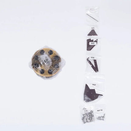 Individual plastic bags of assorted metal components, screws, and a large round brass piece, representing a disassembled mechanical steampunk robot Taurus 3D puzzle Metal Kit. This shows the organized packaging for building a challenging steam punk mech and steampunk puzzle.