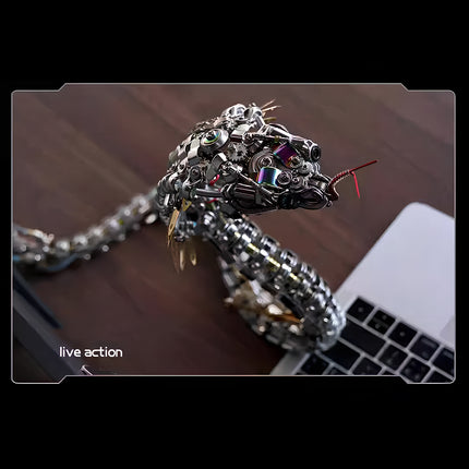 Live action" pose of the metal snake model kit on a wooden surface, showcasing its flexible, articulated body.