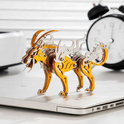 Assembled yellow and silver stylized wolf king metal model 3D puzzle, displayed elegantly on a laptop, making a unique mechanical steampunk desktop decor or challenging metal kit for enthusiasts.