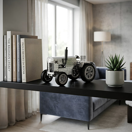 Steam punk mech style tractor metal model displayed next to books, an intricate steampunk puzzle for DIY enthusiasts and collectors.
