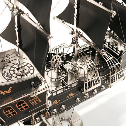 Close-up of the gear-driven deck and ship wheel on a mechanical steampunk pirate ship, a high-precision DIY metal model.