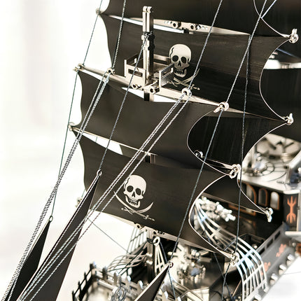 Close-up of the skull-patterned sails and metal rigging on a mechanical steampunk pirate ship, a premium DIY metal model.