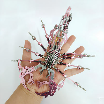 Showing the scale of a pink mechanical steampunk scorpion, a premium metal model and steampunk puzzle project from professional 3D puzzle Metal Kits.