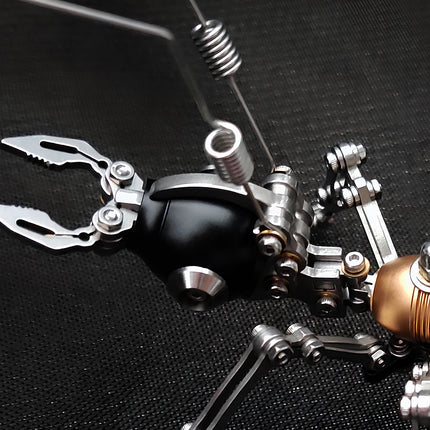 Close-up of the black head and silver mandibles of a mechanical steampunk ant metal model, an intricate 3D puzzle Metal Kits project.