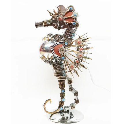 Illuminated **mechanical metal puzzle** seahorse on a stand, displaying a warm starburst-style light bulb and exposed gear mechanisms.