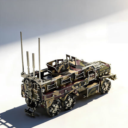 A right rear high-angle view of a completed camo 6x6 tactical armored vehicle metal puzzle showing its detailed tailgate, climbing ladder, rear communications array, and tandem rear axles on a bright white background.