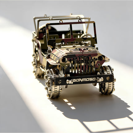 A front low-angle view of the assembled camo willys jeep 3d metal puzzle, showcasing the military camouflage pattern, signature front grille, branded bumper, and heavy-duty gear wheels under sharp lighting.
