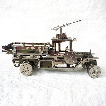 Side profile of a camouflage military truck metal model, featuring a rear cargo bed and top-mounted turret.