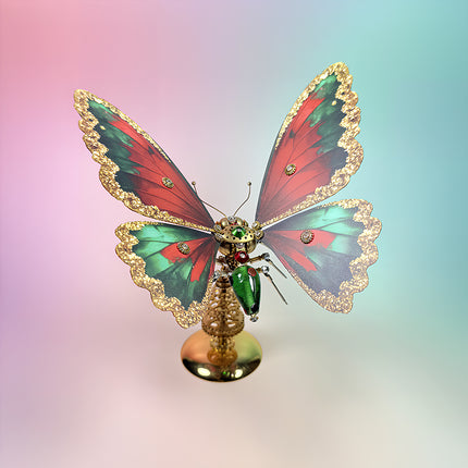 Festive 3D puzzle Metal Kit of a steampunk puzzle butterfly featuring red and green wings and an industrial Christmas tree base.