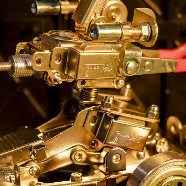 Close-up view of intricate gears and metallic parts on a mechanical steampunk metal model built from 3D puzzle metal kits.