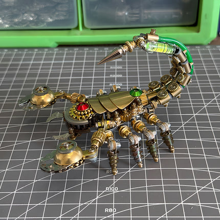Handcrafted steampunk puzzle scorpion on a workshop cutting mat, a detailed 3D puzzle Metal Kit for DIY hobbyists.