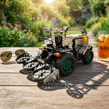 Fully assembled 3D metal harvester model kit displayed on a wooden outdoor patio table in a sunny garden with a drink and sunglasses.