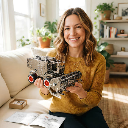 Adult female craft enthusiast showcasing a detailed metallic 3D combine harvester model puzzle in a warm home atmosphere.