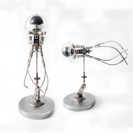 Dual-pose display photo showing an assembled 3D metal mechanical jellyfish model in both vertical standing and horizontal swimming modes on metallic stands.