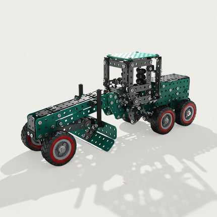 A 3D render of a completed green mechanical motor grader metal model kit, showcasing the long front chassis, adjustable middle scraper blade, and red-rimmed wheels against a white background.