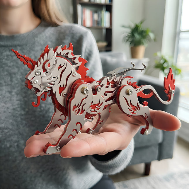A person holding a completed red and silver Kirin mythical beast, showing the desktop scale of this mechanical steampunk metal model and 3D puzzle Metal Kit.