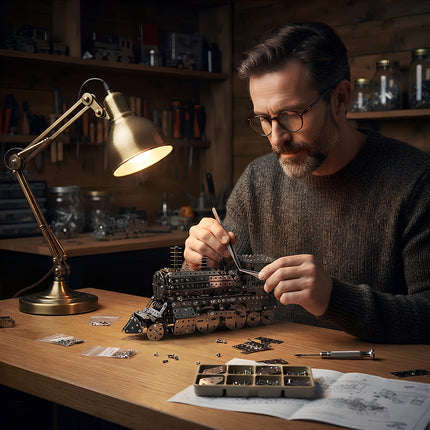 A man using precision tweezers to assemble a 3D metal steam locomotive model under a desk lamp in a cozy workshop.