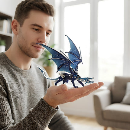 A man holding an assembled blue and silver 3D metal mechanical dragon model in his palm at home.