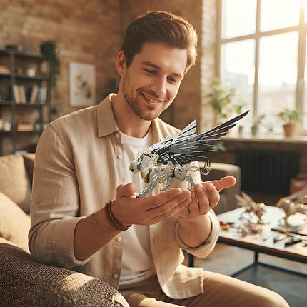 A satisfied hobbyist holding a finished winged lion metal model in his hands, showcasing the scale of this premium mechanical steampunk 3D puzzle Metal Kit.