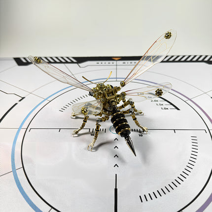 A collectible DIY steampunk puzzle of a robotic bee, an exquisite metal model displayed on a technical calibration mat.