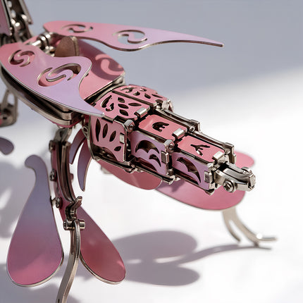 Intricate tail and wing assembly of a pink mechanical steampunk insect model for aesthetic desk decor.