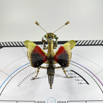 A collectible steampunk puzzle praying mantis on a technical mat, featuring high-quality components from our premium metal model series.