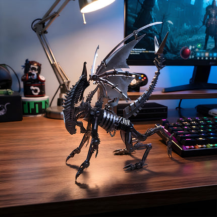 Geek gaming desk setup featuring a completed mechanical steampunk puzzle creature next to a gaming keyboard and desk lamp.