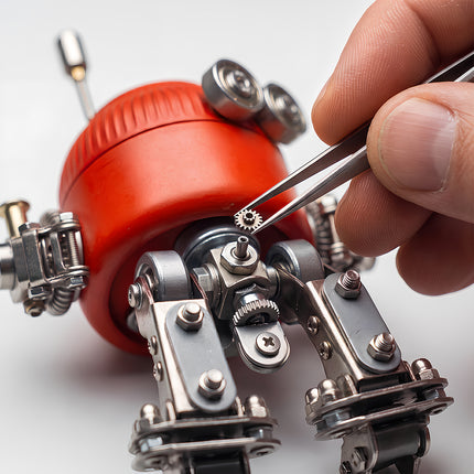 Close-up view of a mechanical steampunk puzzle being assembled with tweezers, highlighting intricate metal gears and parts.