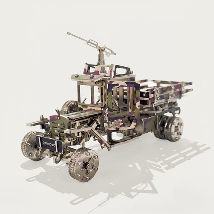 Mechanical steampunk puzzle showing the open door mechanism of a camouflage armed truck metal model.