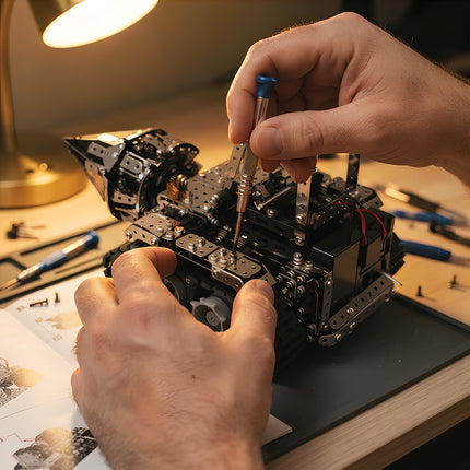 Detailed macro photography of hands building a mechanical steampunk puzzle vehicle kit by tightening screws with a tool.