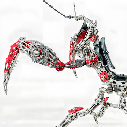 Close-up view of the articulated forelegs and head of a dynamic metal praying mantis model, highlighting the complex gear mechanisms and sharp red and silver components. This DIY 3d puzzle metal model showcases engineering artistry.
