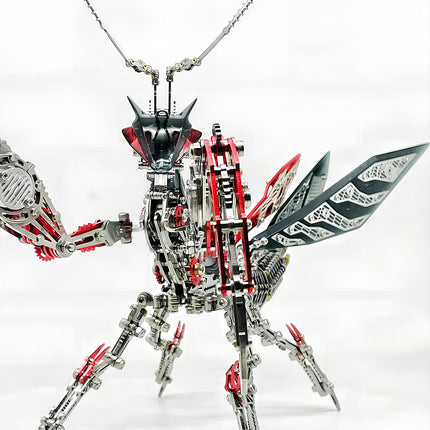 A striking metal praying mantis model, featuring intricate silver and red components, posed dynamically against a white background. This detailed 3d puzzle metal kits creation makes an impressive and funny table display.