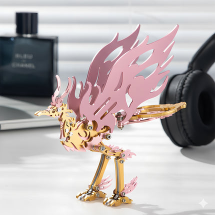 Side-angle view of an assembled pink and gold Bi Fang bird 3D metal mechanical puzzle standing on a white desk with lifestyle props.