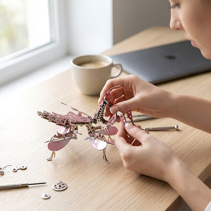 Pink metallic mechanical praying mantis 3D puzzle model kit, a creative DIY craft kit and desk ornament gift for women.