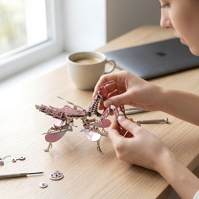 Pink metallic mechanical praying mantis 3D puzzle model kit, a creative DIY craft kit and desk ornament gift for women.