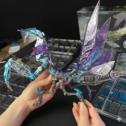 Finished **3D metal puzzle** of a cyberpunk mantis with purple wings, displayed in a workspace environment.