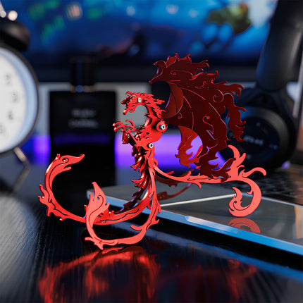 A finished red steam punk mech Zhuque phoenix metal model displayed on a dark tech aesthetic gaming desk setup.