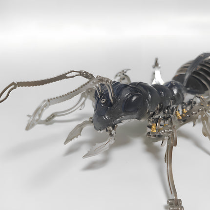 Close-up view of precision metal joints, screws, and simulated ant head features on a steampunk mechanical ant puzzle kit.