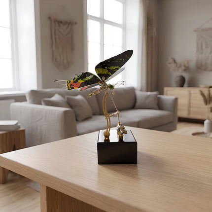 Elegant steampunk mechanical butterfly sculpture on a wooden coffee table as a modern home decor piece.