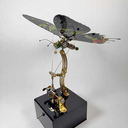 Detailed side view of a steampunk mechanical butterfly model showing curved support pole and drive linkage.