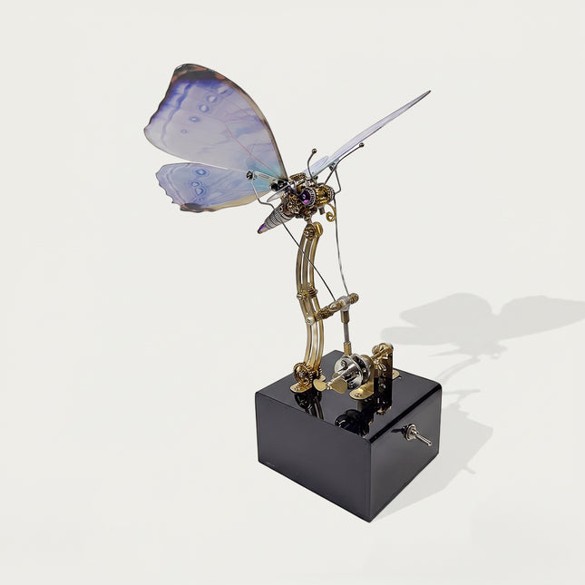 Side-angle view of a steampunk mechanical butterfly sculpture with moving gears on a black power base for desktop display.