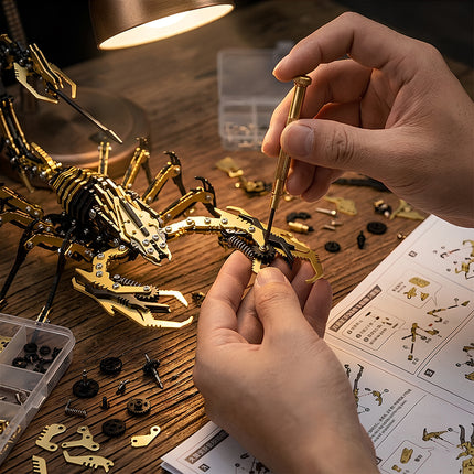 Engaged in building a golden steampunk puzzle scorpion, an example of advanced 3D puzzle Metal Kits for hobbyists and fans of steam punk mech aesthetics.