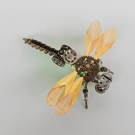 Clean top-angle view of the assembled steampunk puzzle dragonfly model against a plain white background, without text overlays. This exquisite metal model highlights the intricate filigree wings, gear chest, and chain-segmented tail built from premium 3D puzzle Metal Kits, making it a stunning steam punk mech / mechanical steampunk addition to any collection.