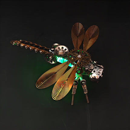 A dramatic dark-background shot of a steampunk puzzle dragonfly model illuminated with a brilliant green glow. This striking metal model crafted from 3D puzzle Metal Kits highlights the glowing thorax and metallic wings, making it a stunning steam punk mech / mechanical steampunk piece for nighttime display.